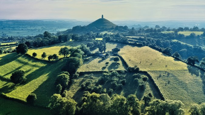 Glastonbury Tor drone image, England - image by Niklas Weiss on Unsplash https://unsplash.com/photos/green-leafed-trees-at-daytime-W2tisCgfu8A
