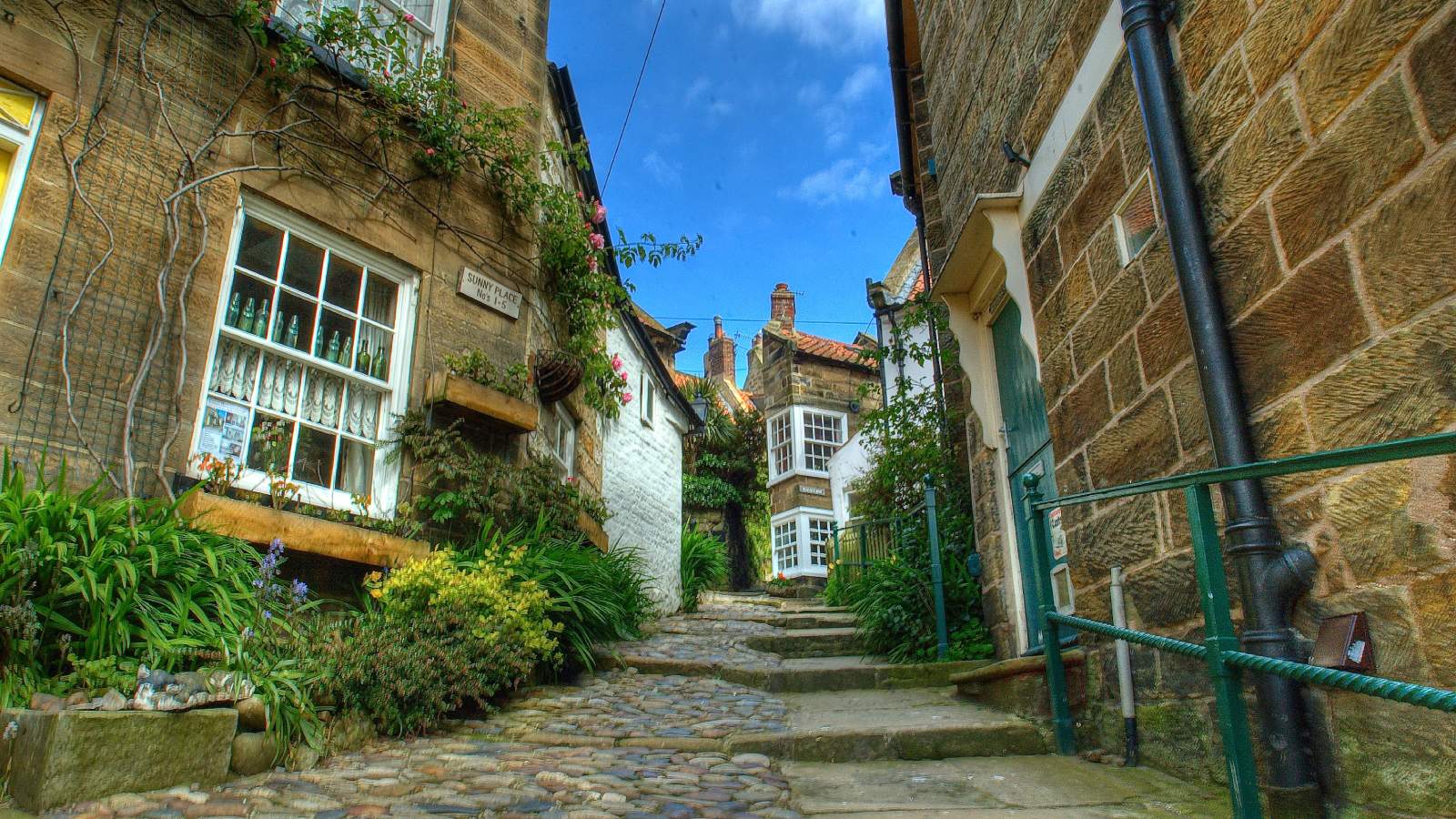 Robin Hood's Bay, England - image by Herkuleshippo https://commons.wikimedia.org/wiki/File:Windy_street_in_Robin_Hoods_Bay_near_Whitby_North_Yorkshire.jpg